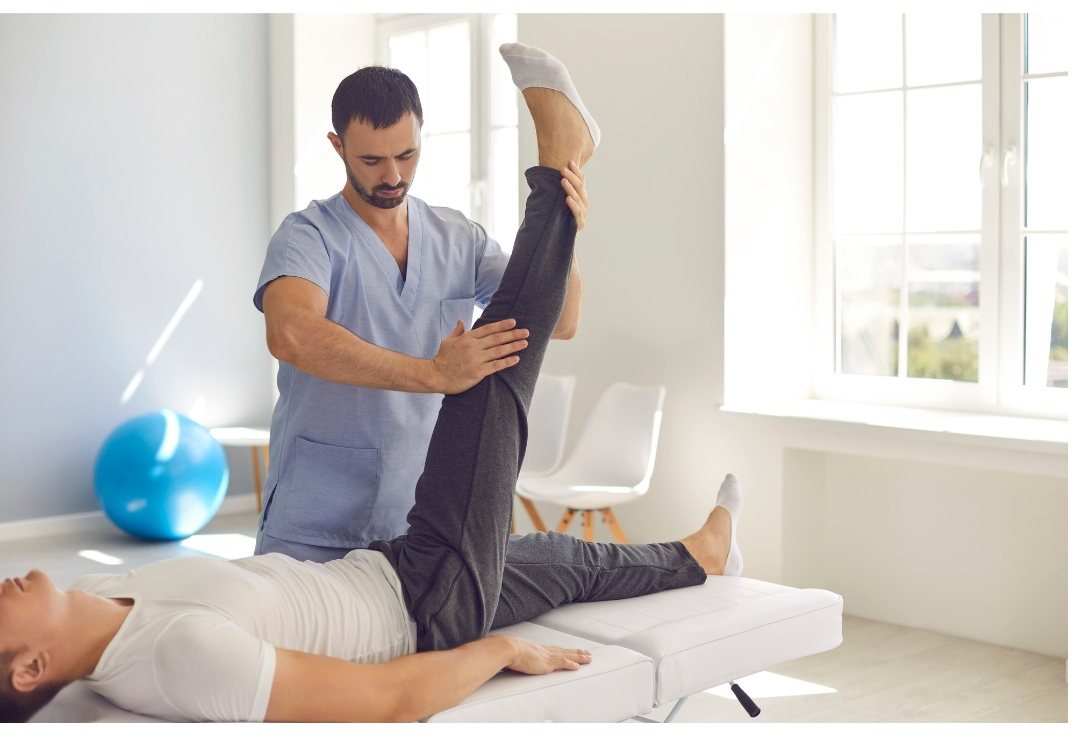 Physiotherapist guiding a patient through a mobility exercise at RMC Mangalore